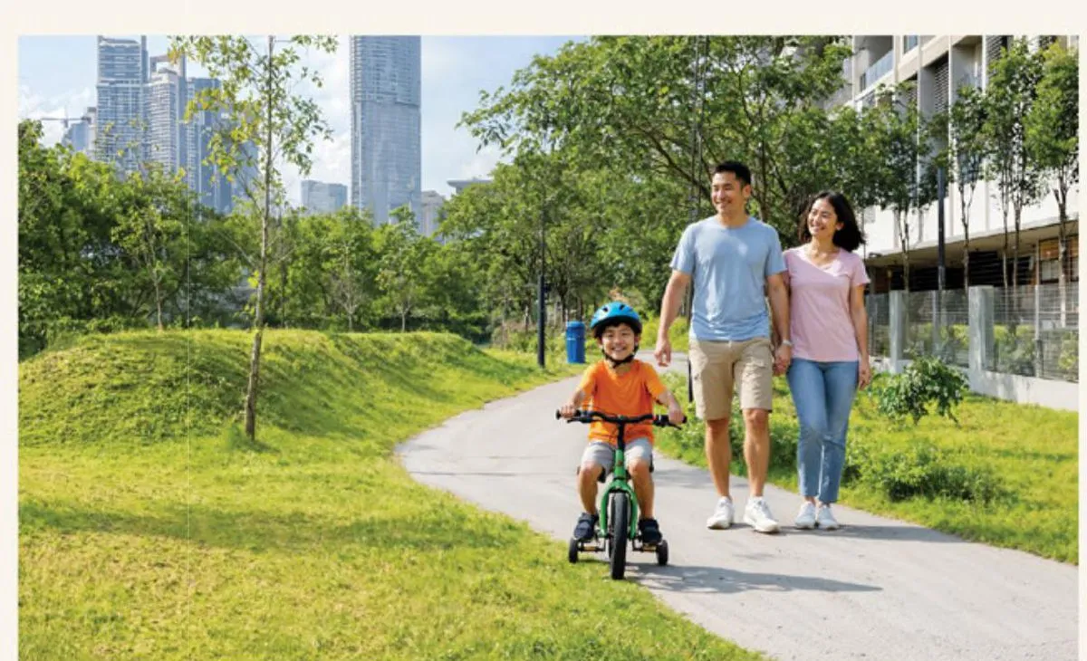 A family cycling and walking along the Promenade Boulevard riverside park